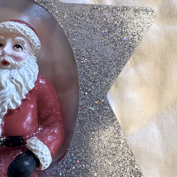 A Glittering Silver Star Christmas Ornament with a jolly Santa holding a Tree - Picture 3 of 6